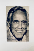 Autographed vintage black and white portrait photo of actor Jason Robards signed in blue ink.