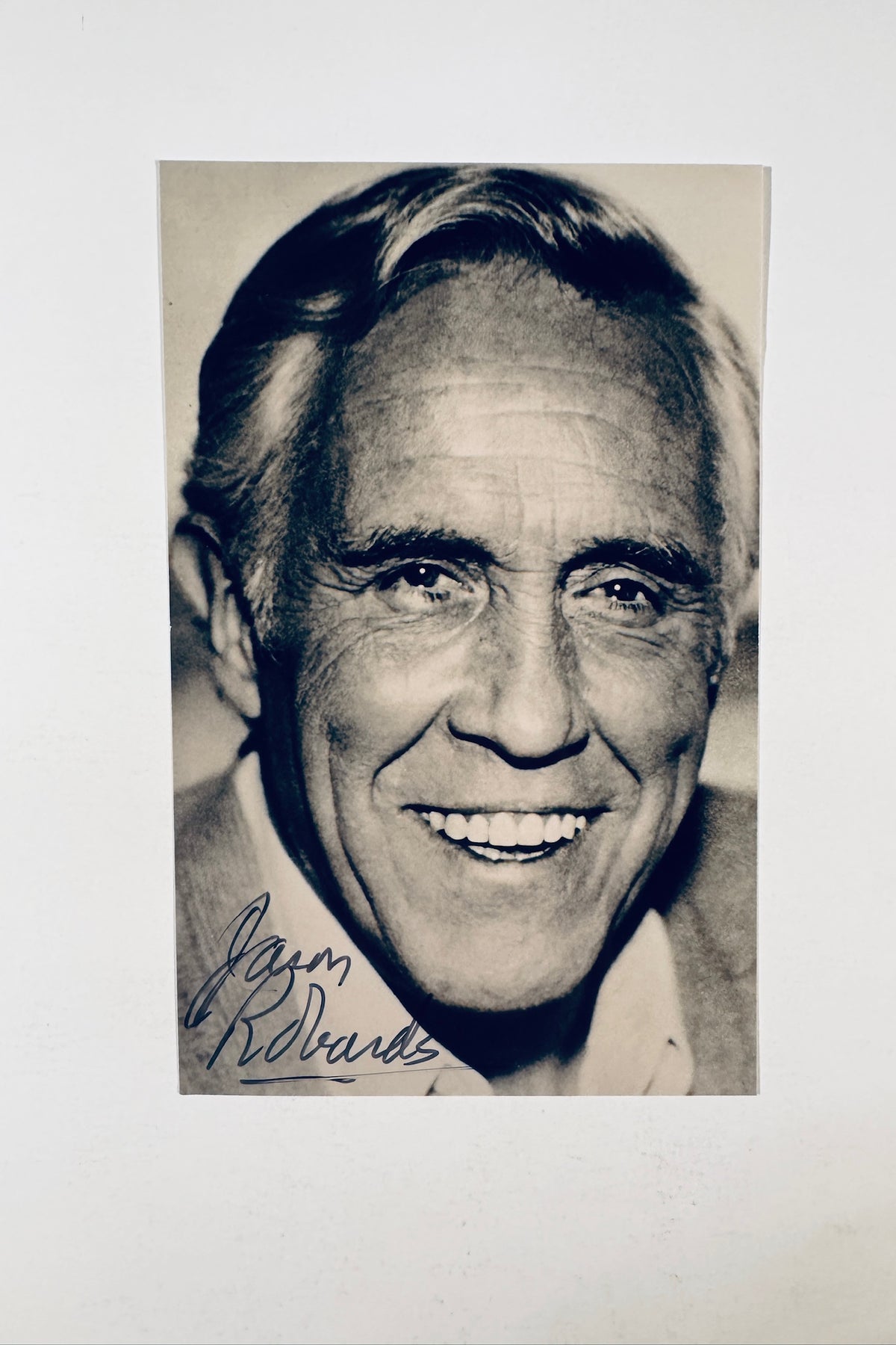Autographed vintage black and white portrait photo of actor Jason Robards signed in blue ink.
