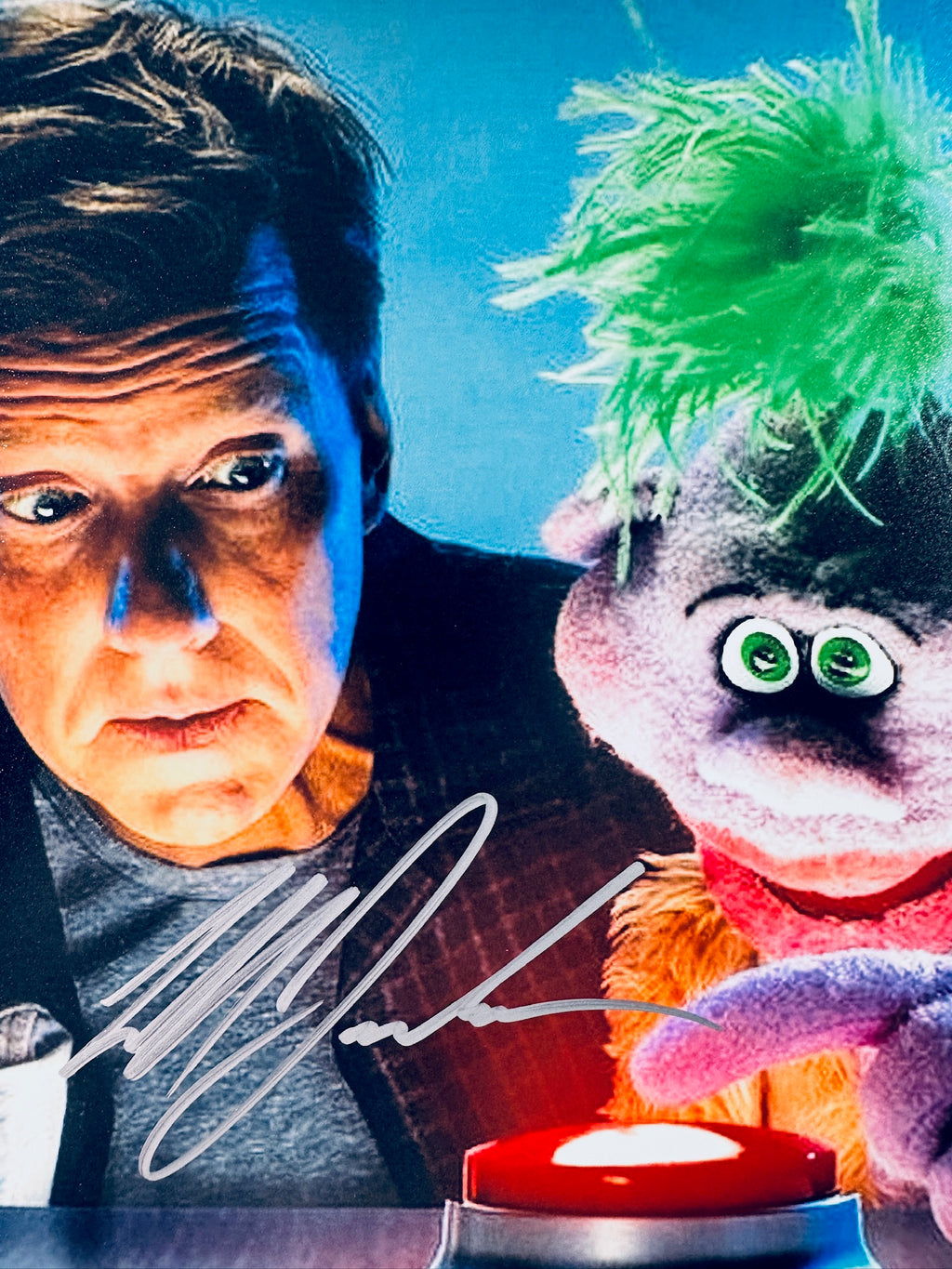 Close-up view of Jeff Dunham's signature in silver marker across the Crank Yankers promotional photo.