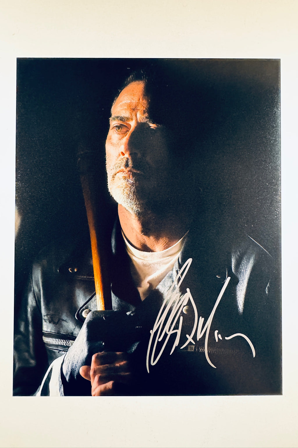 A portrait of Jeffrey Dean Morgan as Negan from The Walking Dead holding his bat Lucille, featuring a signature in white/silver ink on the lower right.
