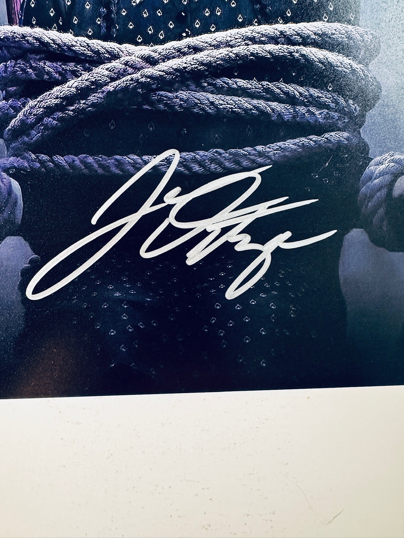 Close-up of Jenna Ortega's signature in silver marker on the signed Wednesday 8x10 photo.