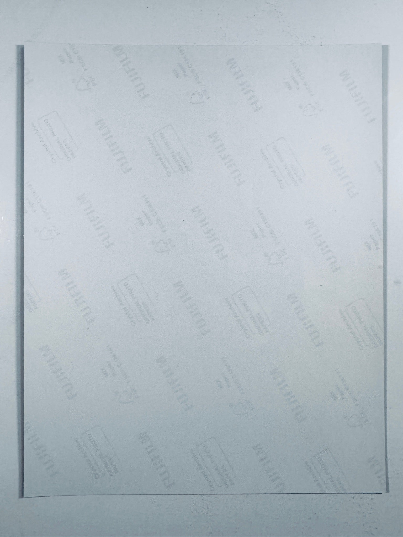 The plain white reverse side representing the back physical condition of the The Hunger Games: Catching Fire photograph print, showing translucent Fujifilm crystal archive paper watermarks and logos.
