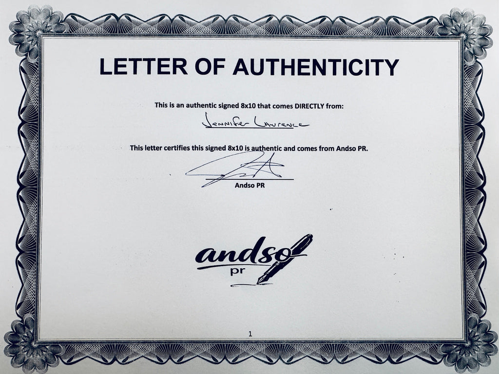 A Letter of Authenticity with a decorative blue-patterned border for The Hunger Games: Catching Fire signed 8x10, certifying an authentic autograph coming directly from Jennifer Lawrence, featuring a signature at the top.