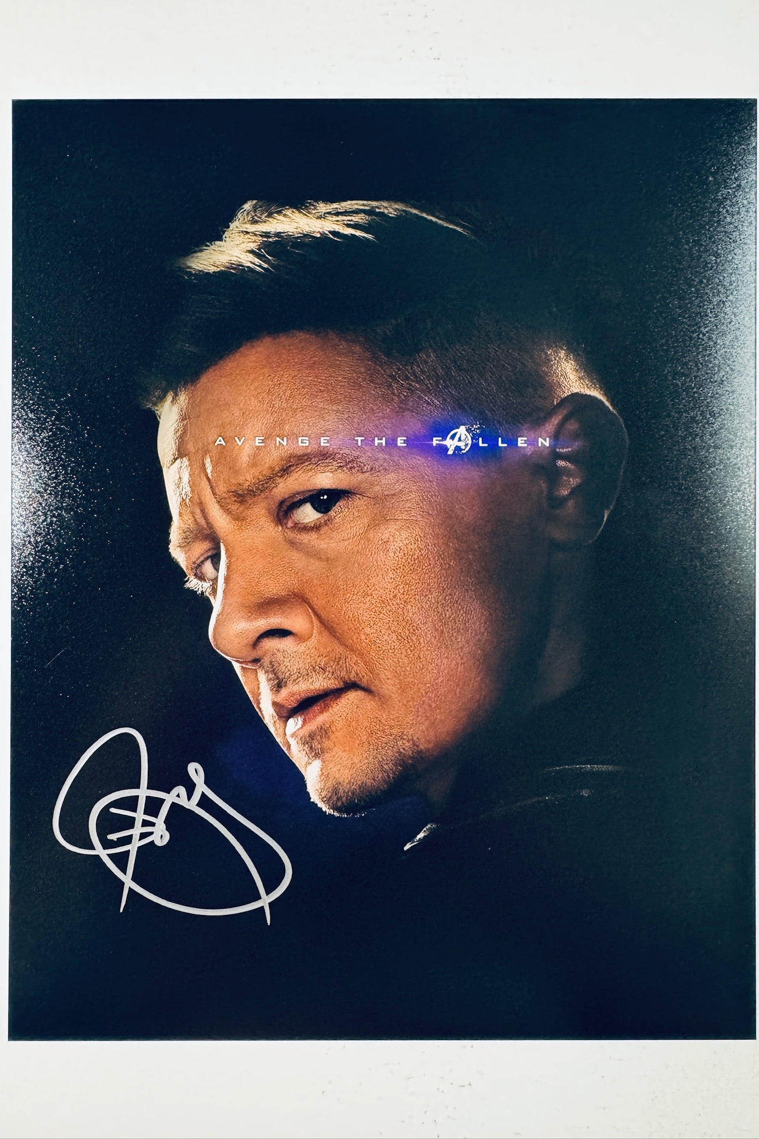 Signed 8x10 matte promo photo of Jeremy Renner as Hawkeye from Avengers Endgame with the Avenge the Fallen banner, featuring a bold silver ink autograph.