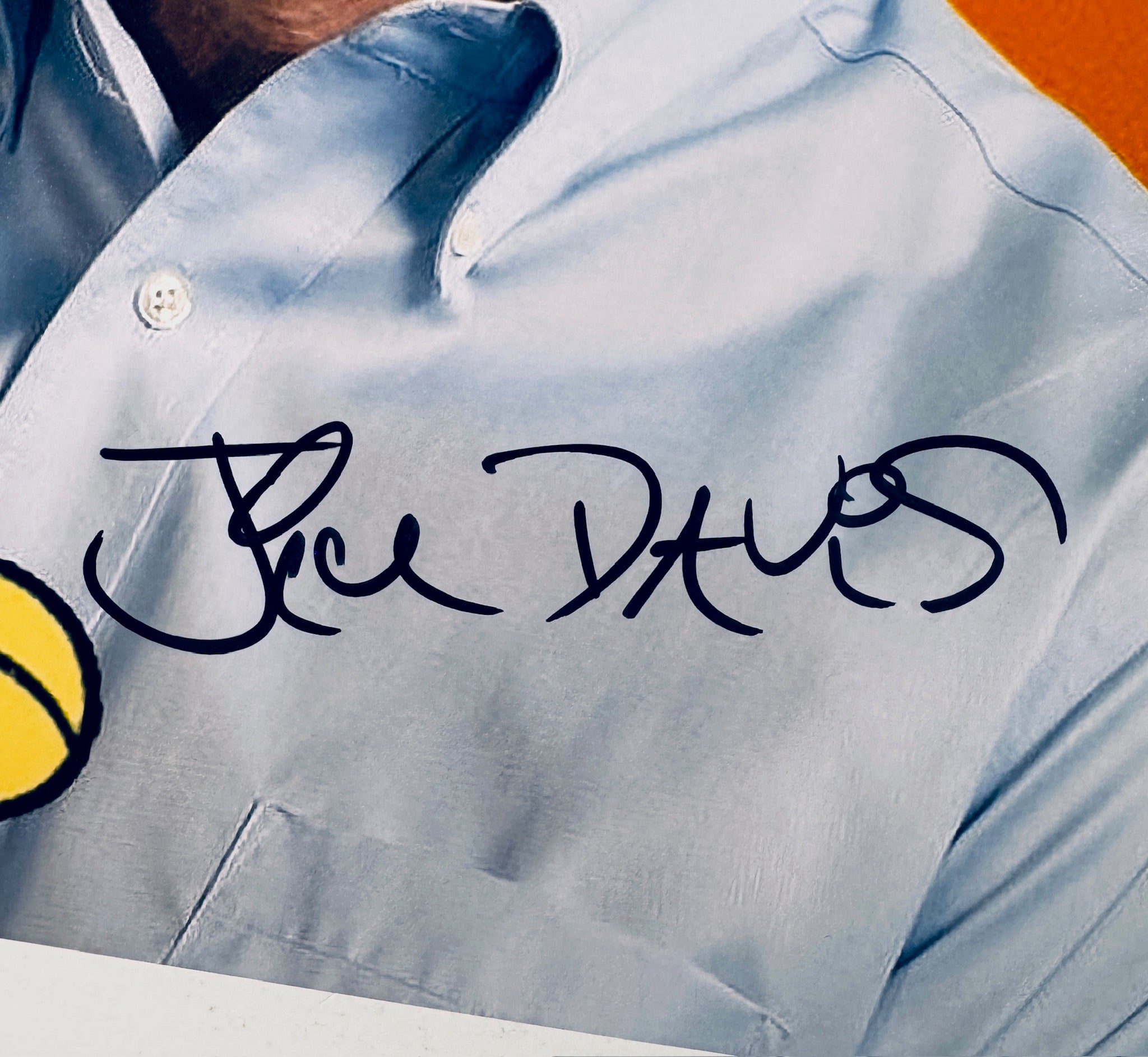 Close-up of Jim Davis's signature in black marker on the signed Garfield 8x10 photo.
