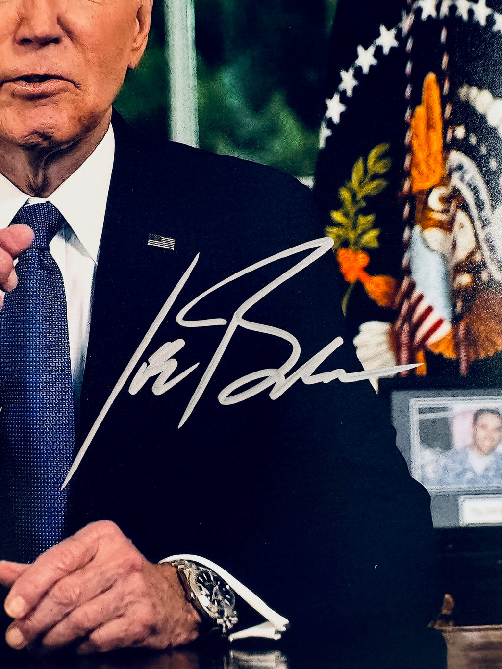 Close-up of Joe Biden's signature in silver marker on the signed 8x10 photo.