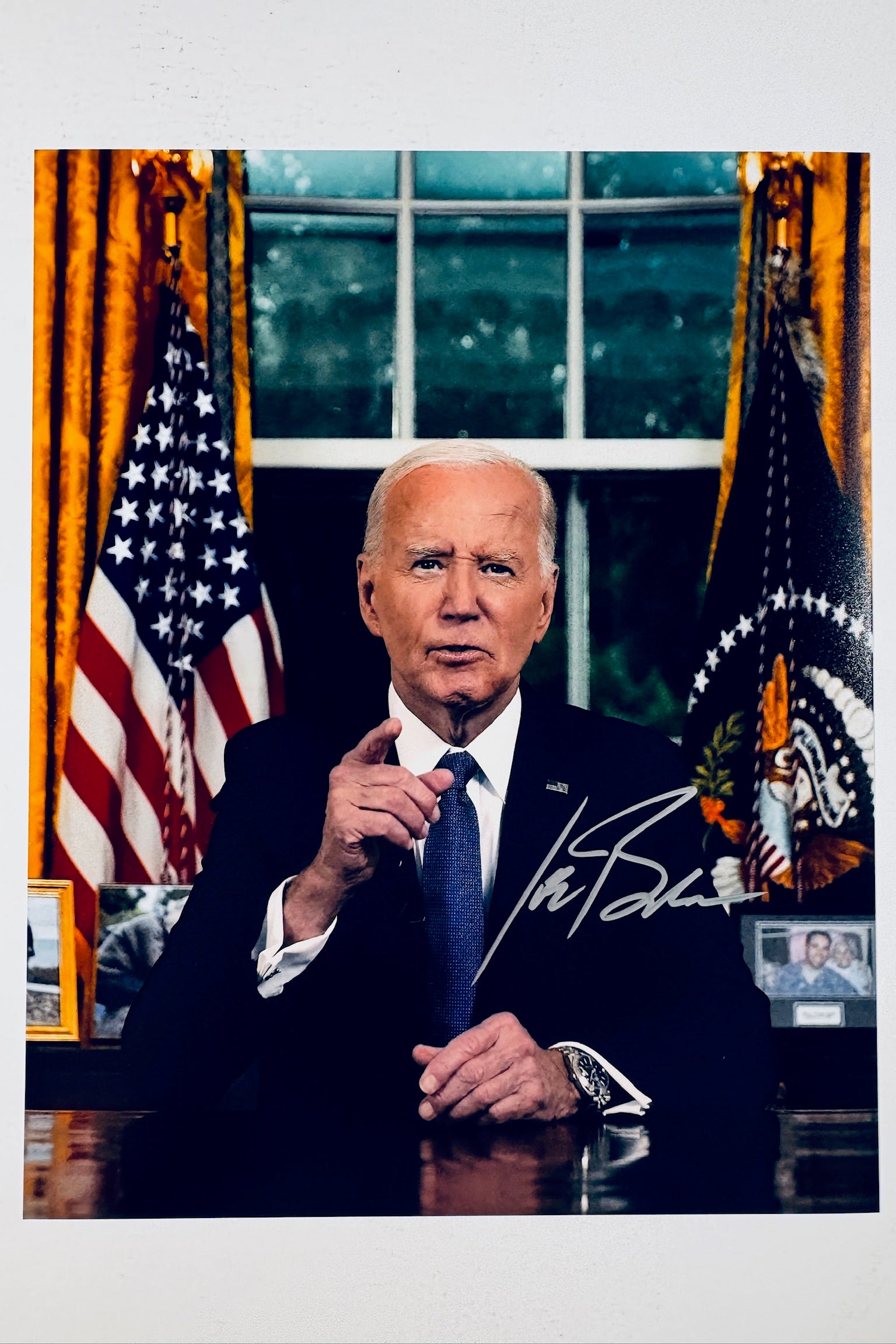 Joe Biden hand-signed 8x10 matte photo in the Oval Office with the American flag and presidential seal flag in the background.