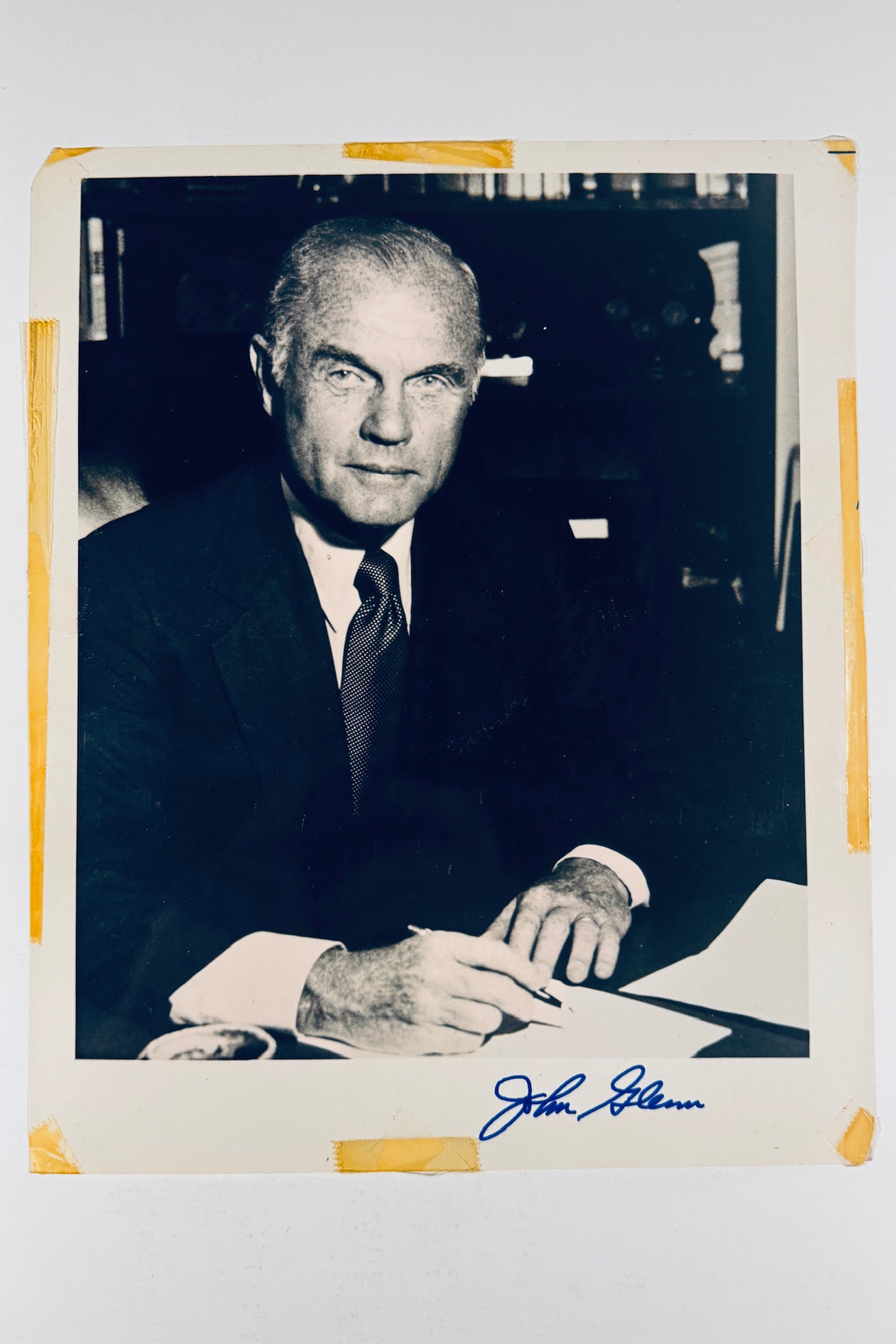 Full front view of vintage black and white John Glenn portrait photo hand-signed in blue ink on the lower margin.