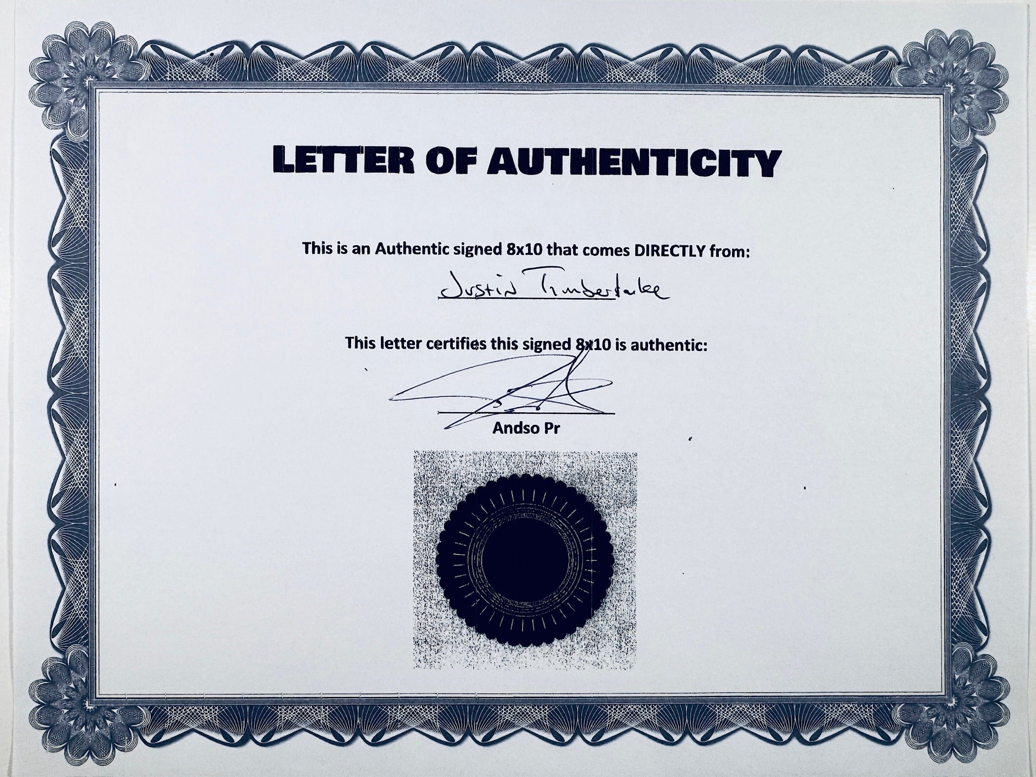 A Letter of Authenticity with a decorative blue-patterned border, certifying an authentic signed 8x10 coming directly from Justin Timberlake, featuring a dark circular seal graphic at the bottom.