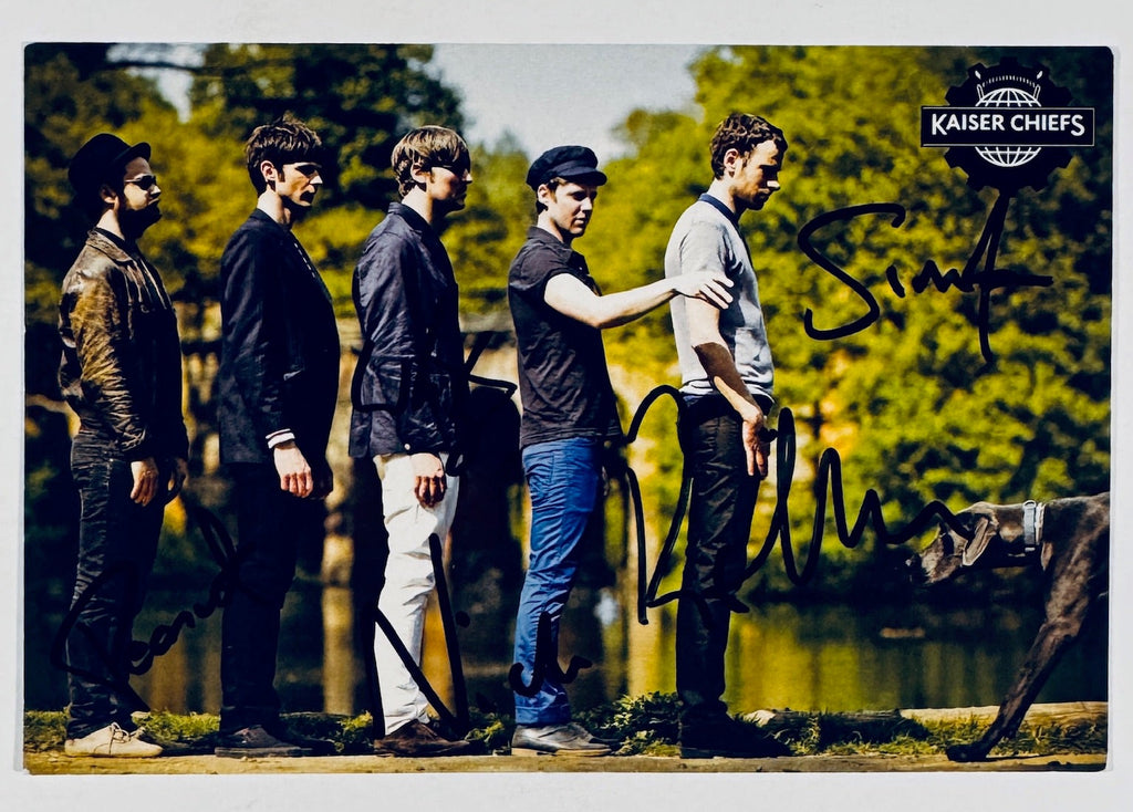 Full front view of official Kaiser Chiefs promotional postcard hand-signed by band members in black marker.