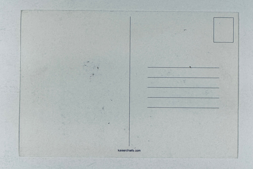Full back view of blank, unposted Kaiser Chiefs promotional postcard showing address lines and website URL.