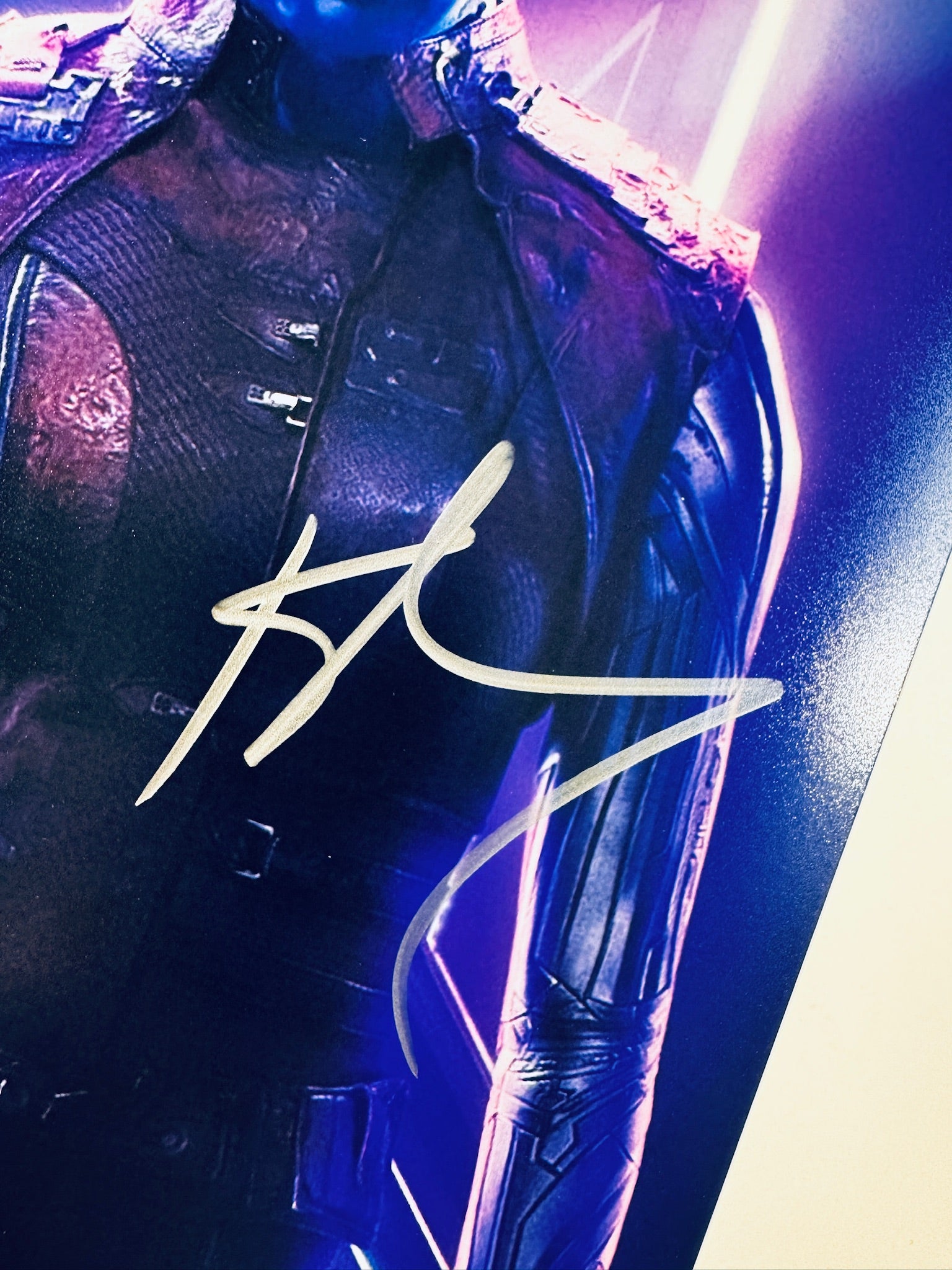 Close-up view of Karen Gillan's silver signature across the front of the Guardians of the Galaxy promotional photograph.