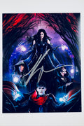 Signed full photo of Kathryn Hahn surrounded by the coven from Agatha All Along with magical energy, featuring a gold autograph.