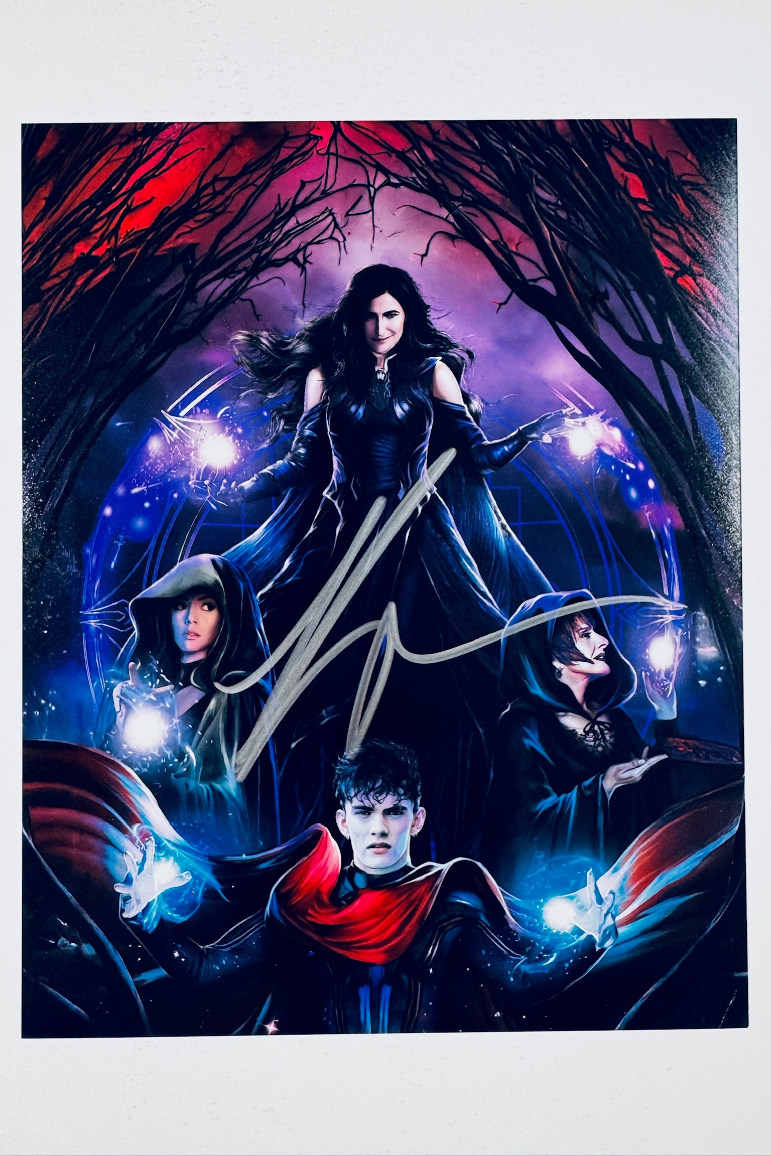 Signed full photo of Kathryn Hahn surrounded by the coven from Agatha All Along with magical energy, featuring a gold autograph.