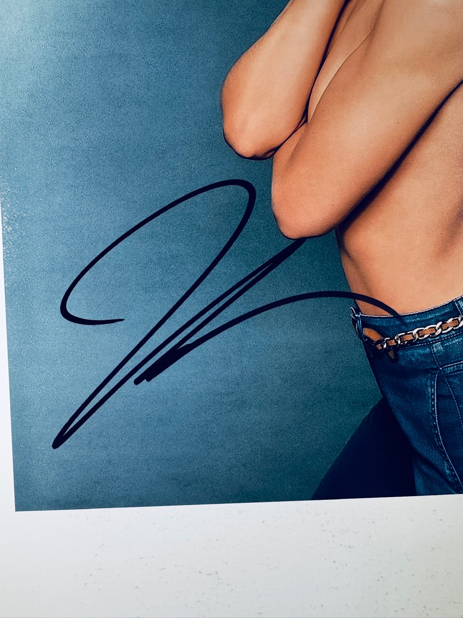 Close-up view of Katie Holmes's black signature across the lower section and waist of the promotional photograph.