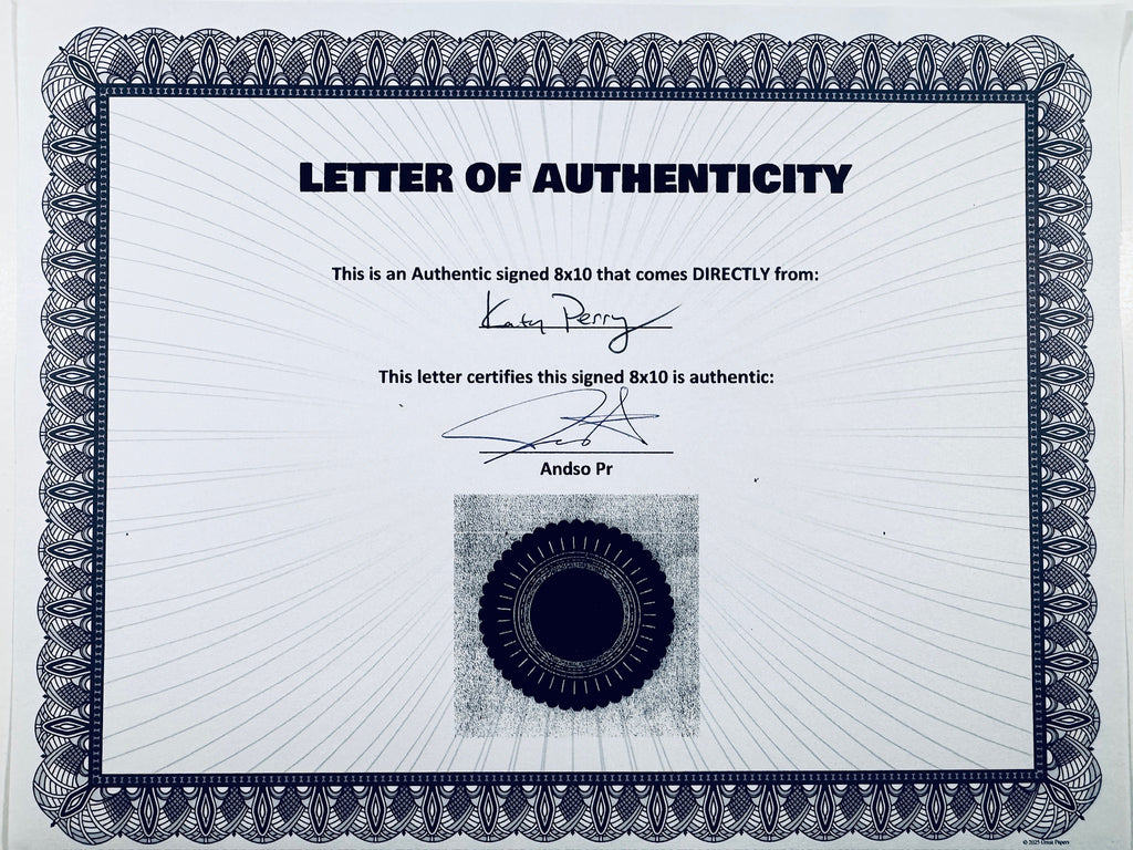 A Letter of Authenticity with a decorative blue-patterned border, certifying an authentic signed 8x10 coming directly from Katy Perry, featuring a dark circular seal graphic at the bottom.
