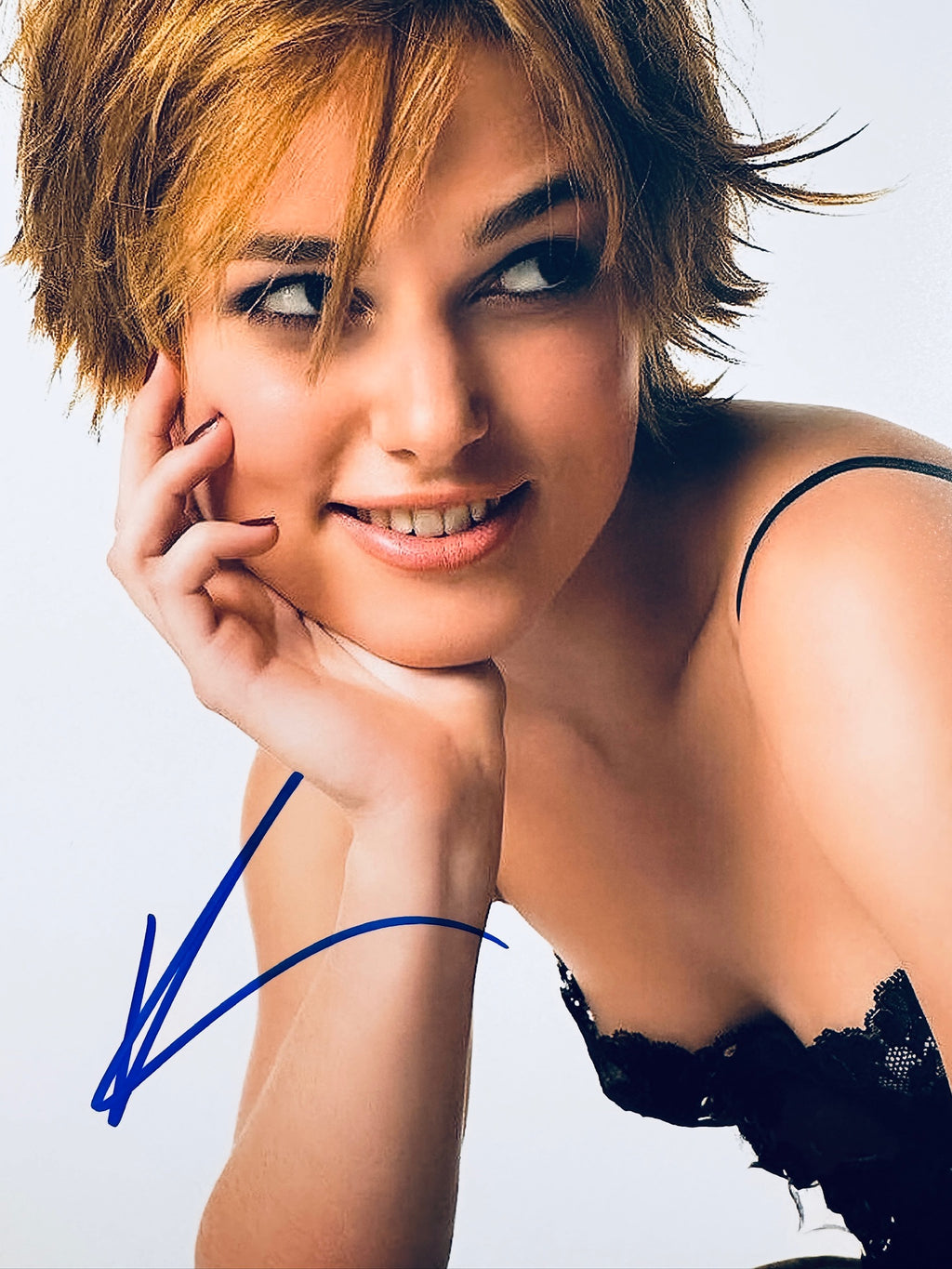 Close-up view of Keira Knightley's signature in blue marker across the promotional matte photo.