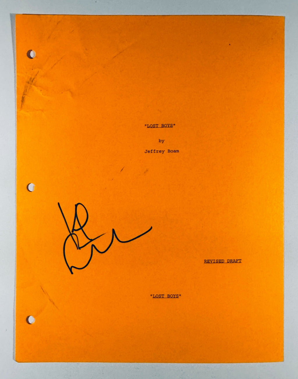 Full front view of orange The Lost Boys script cover page hand-signed by actor Kiefer Sutherland.
