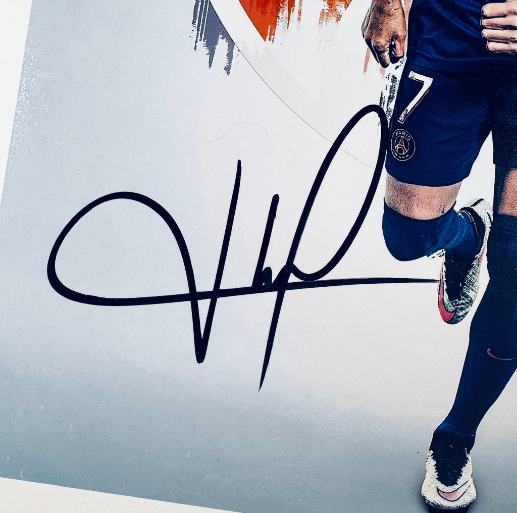 Close-up of Kylian Mbappe's signature in black marker on the signed Paris Saint-Germain 8x10 photo.
