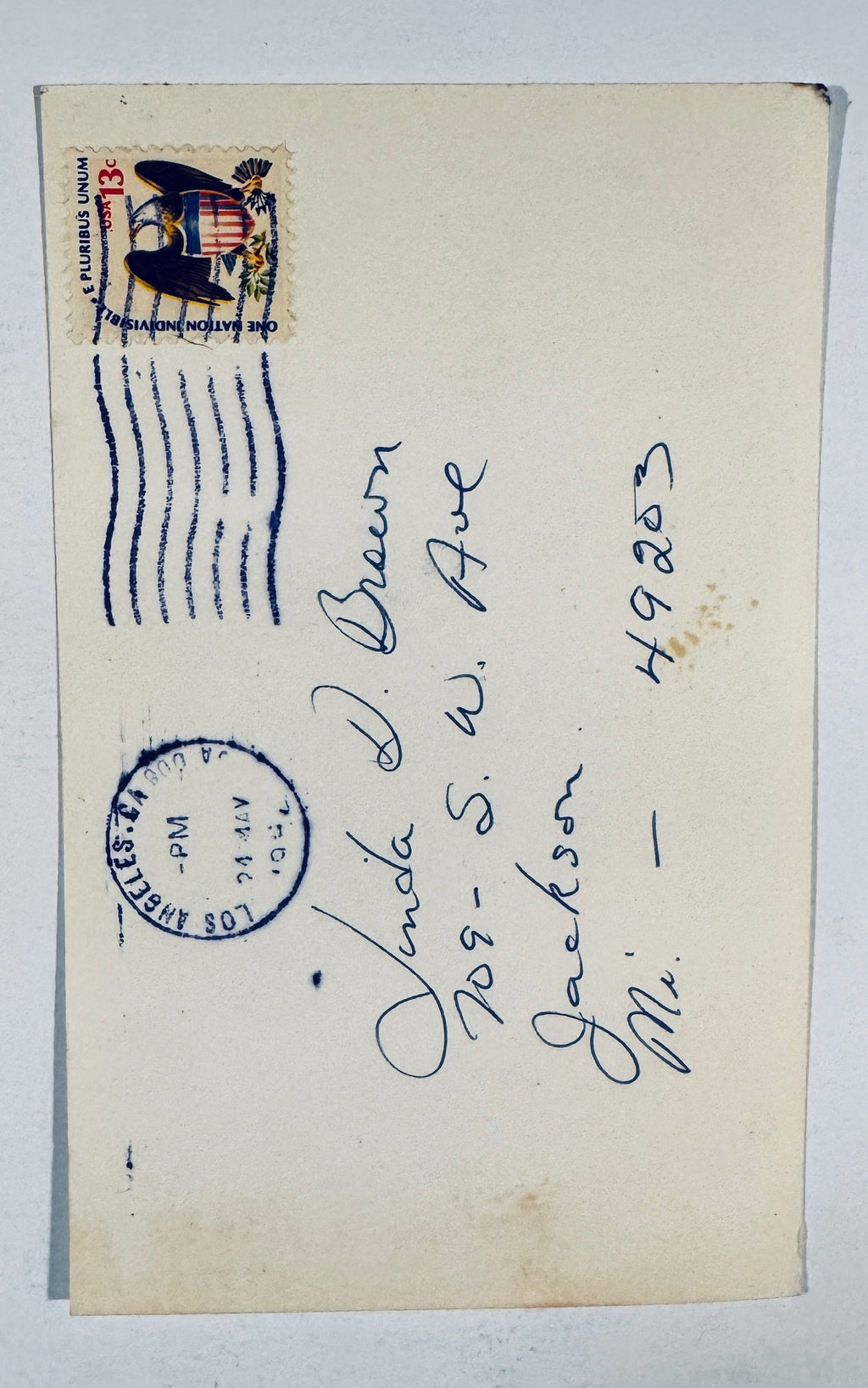 Reverse back view of vintage Leslie Nielsen autographed photo postcard showing 13 cent eagle stamp and Los Angeles postmark.