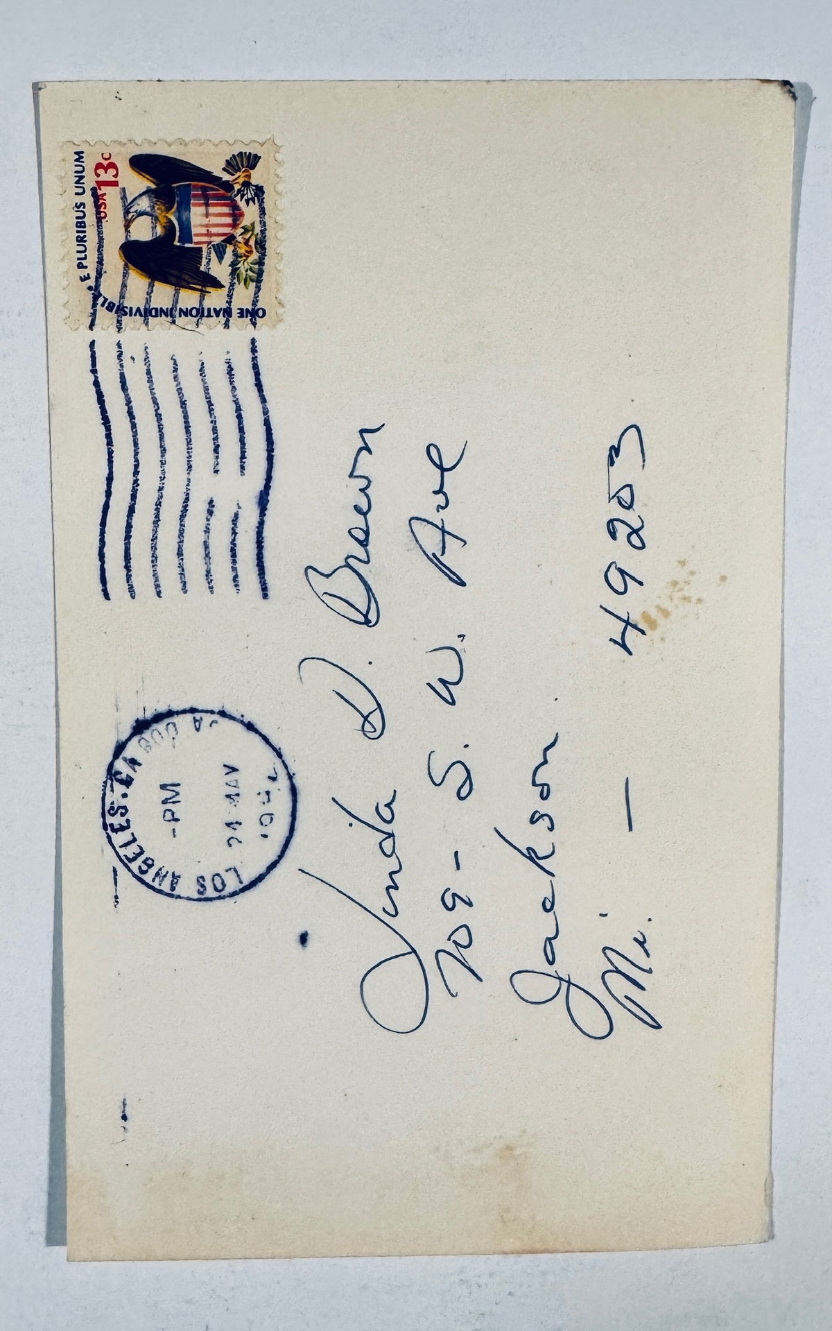 Reverse back view of vintage Leslie Nielsen autographed photo postcard showing 13 cent eagle stamp and Los Angeles postmark.