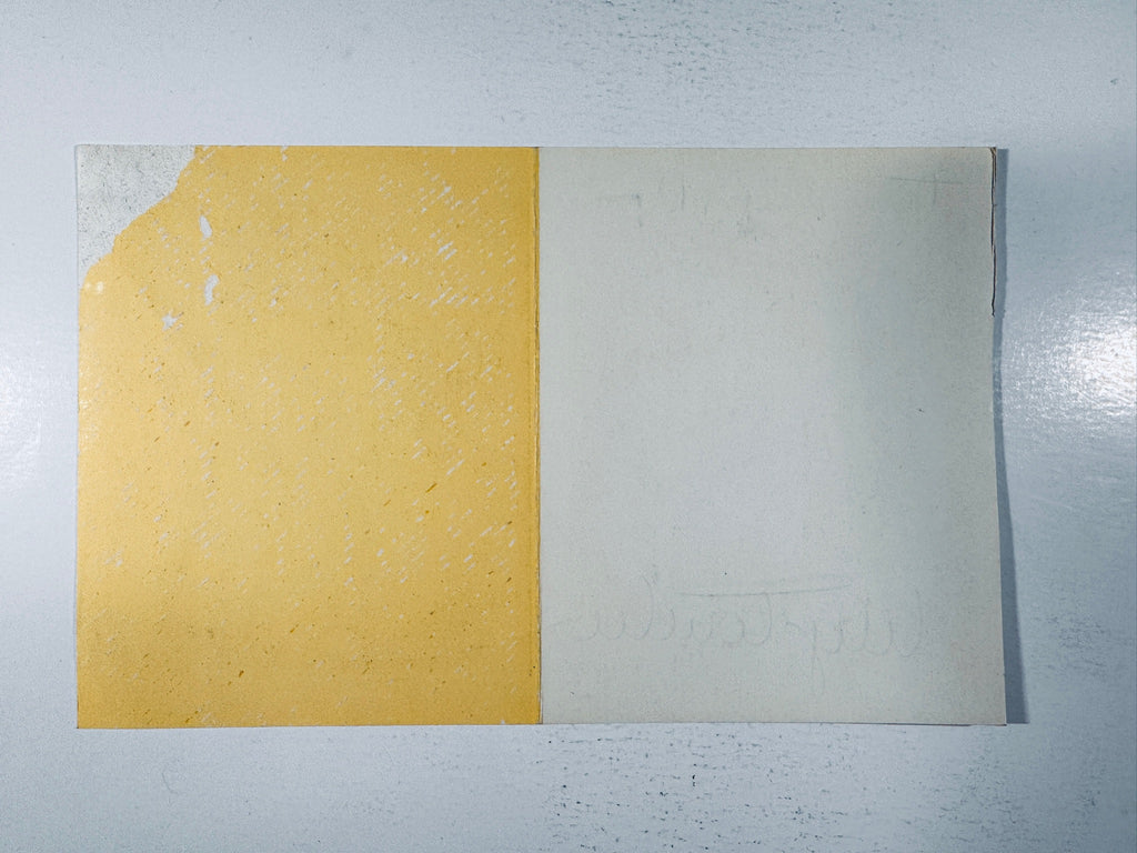Back view of the vintage Lily Tomlin autographed promotional card showing paper texture and blank backing.