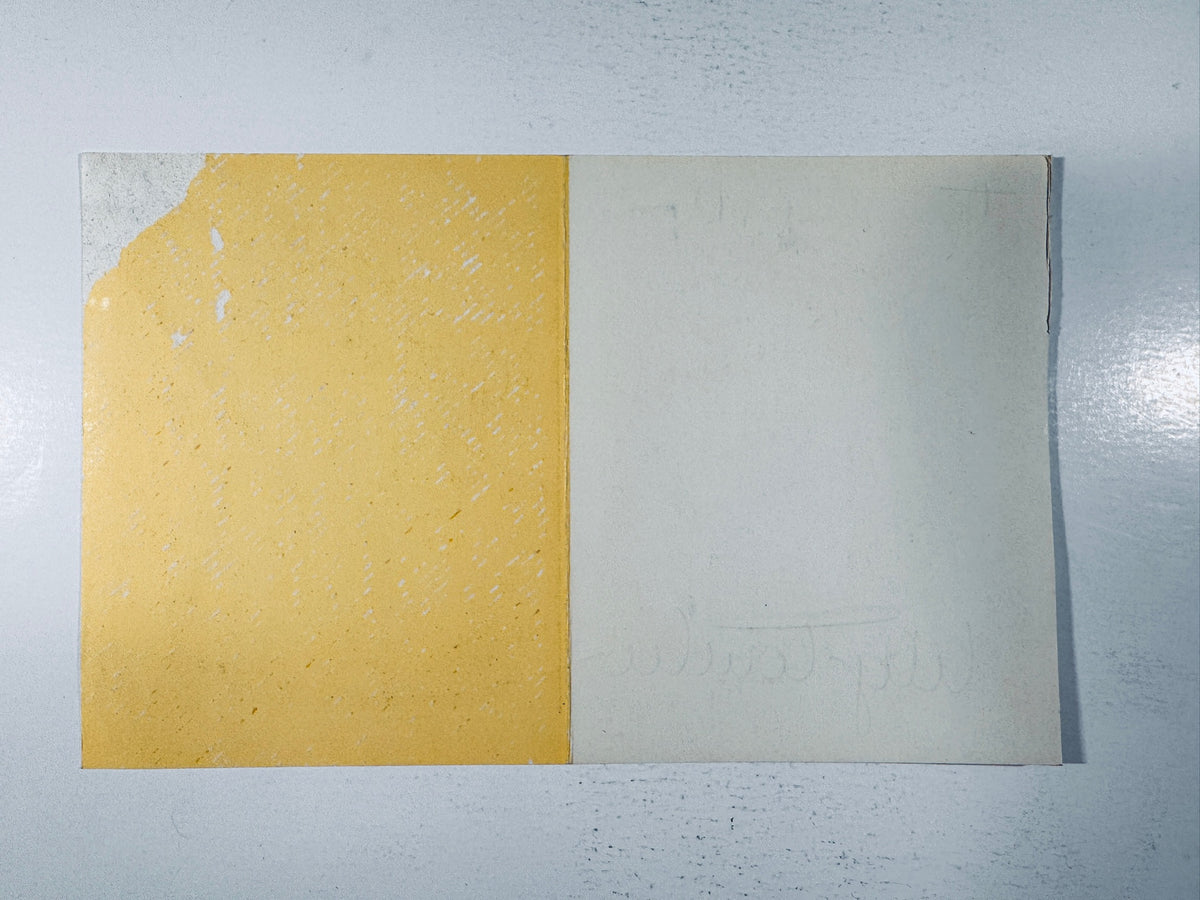 Back view of the vintage Lily Tomlin autographed promotional card showing paper texture and blank backing.