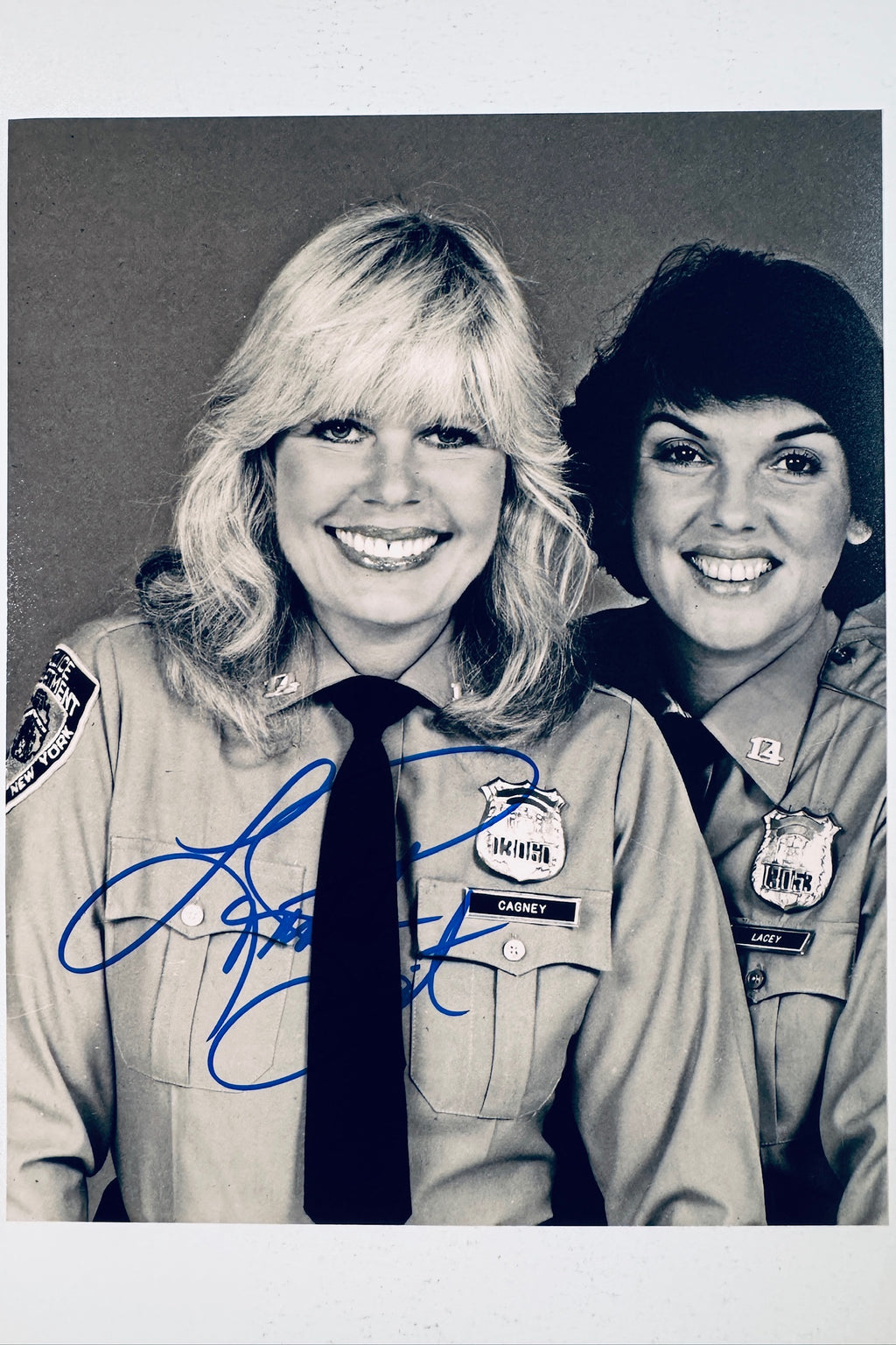 Signed 8x10 matte promotional photo of actress Loretta Swit as Detective Chris Cagney from Cagney & Lacey in a police uniform, featuring a bold blue ink autograph.