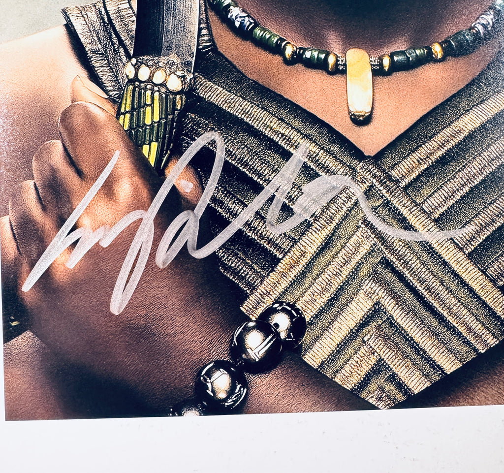 Close-up of Lupita Nyong'o's signature in silver marker on the signed Black Panther 8x10 photo.