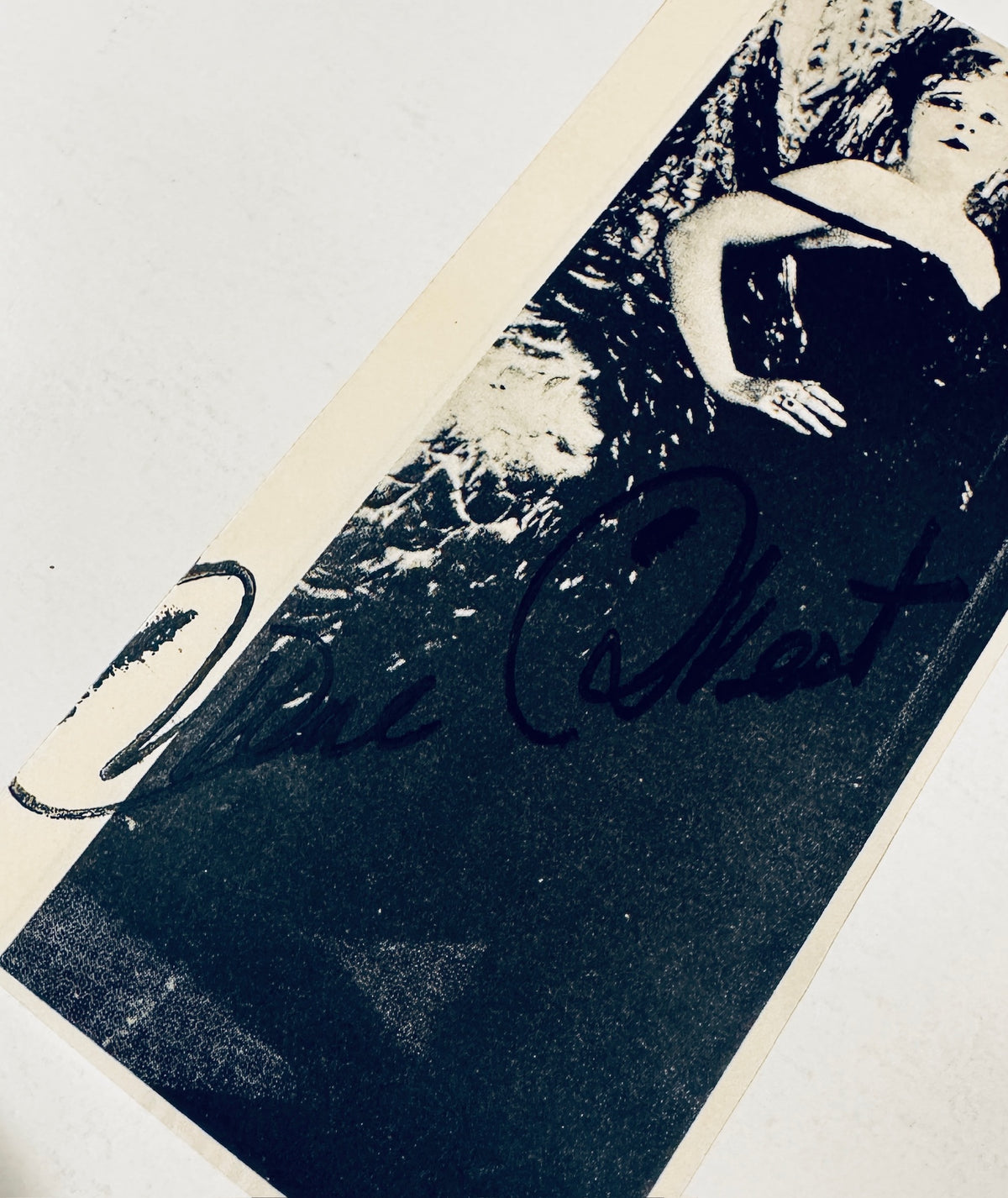 Close-up angled view of Mae West autograph signature written in dark ink across the front.