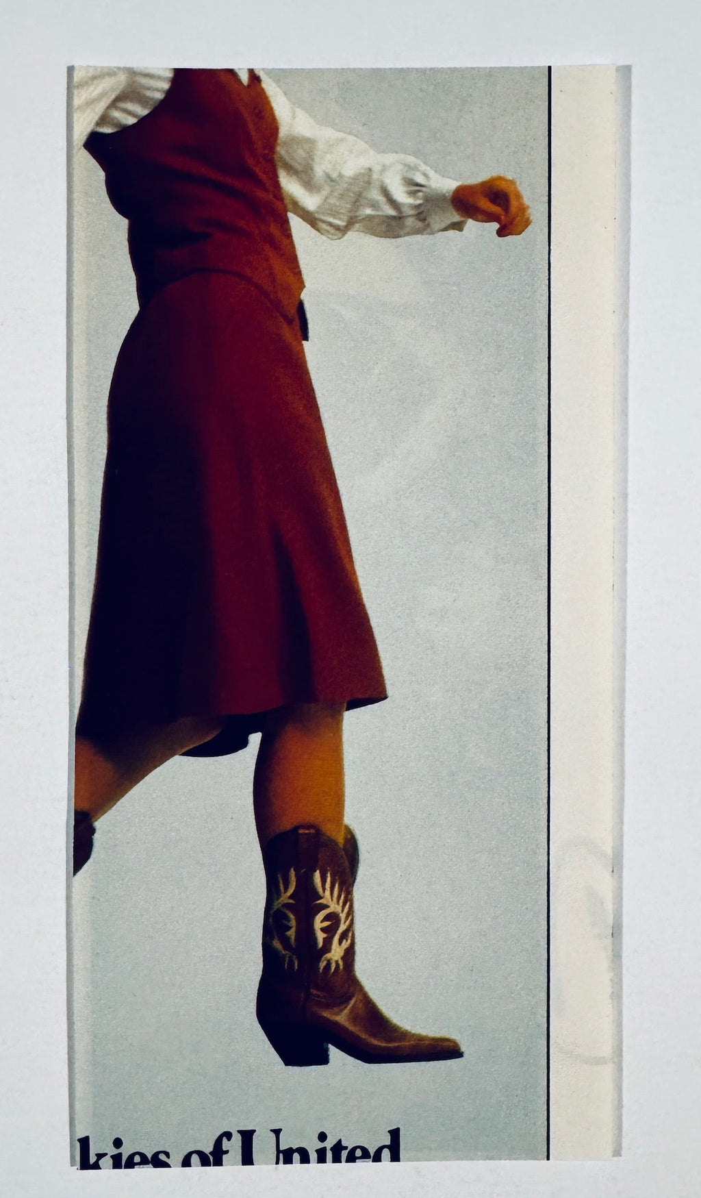 Back side of vintage clipping showing a color image of a woman wearing a dress and cowboy boots.