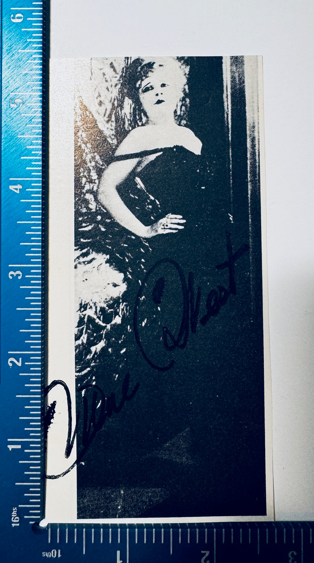 Mae West signed photo clipping shown next to a ruler measuring approximately 2.75 by 5.75 inches.