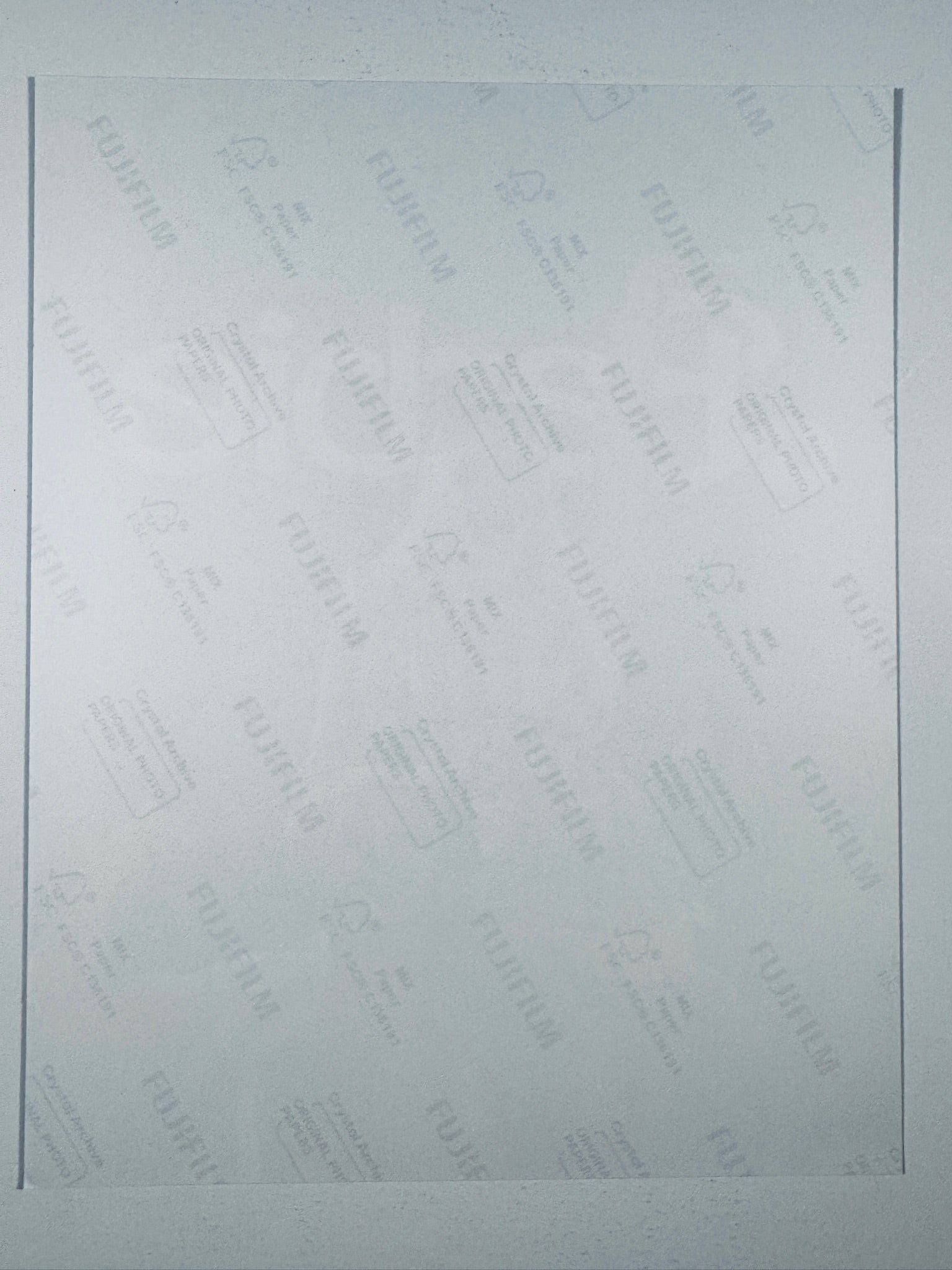 The plain white reverse side representing the back physical condition of the photograph print, showing translucent Fujifilm crystal archive paper watermarks and logos.