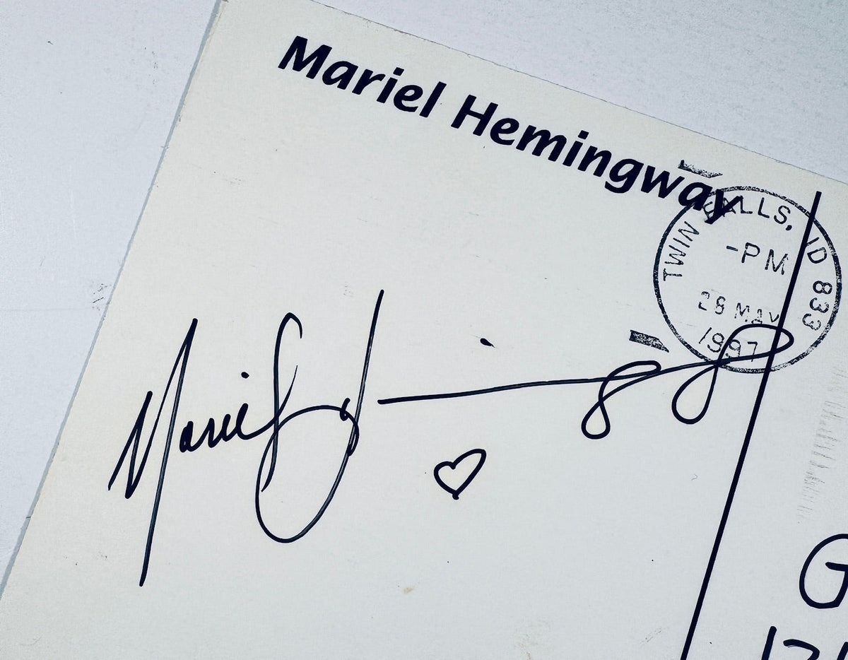Close-up of Mariel Hemingway's black ink signature alongside a postmark stamp and heart design.
