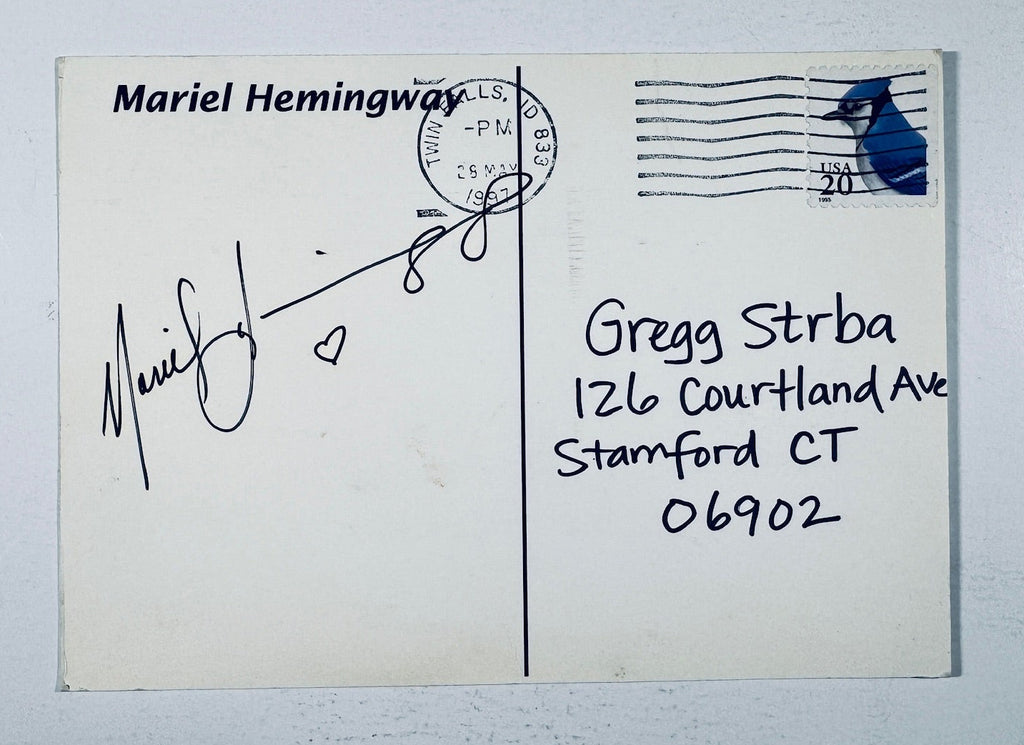 Back of an authentic postmarked postcard autographed by Mariel Hemingway with a hand-drawn heart in black ink.