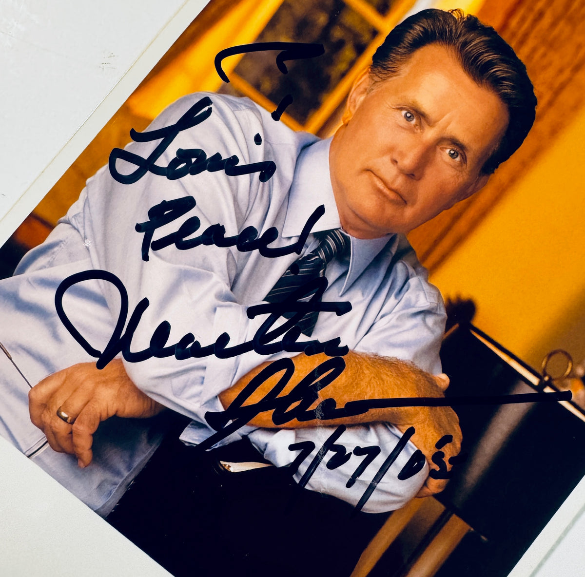 Close-up of Martin Sheen's handwritten signature, peace inscription, and date on a West Wing promotional photo.