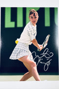 Signed full photo of Martina Hingis playing tennis in a white outfit, featuring a silver autograph.
