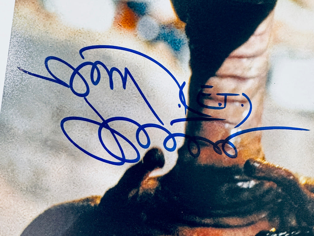 Close-up of Matthew De Meritt's signature in blue marker on the signed E.T. 8x10 photo.