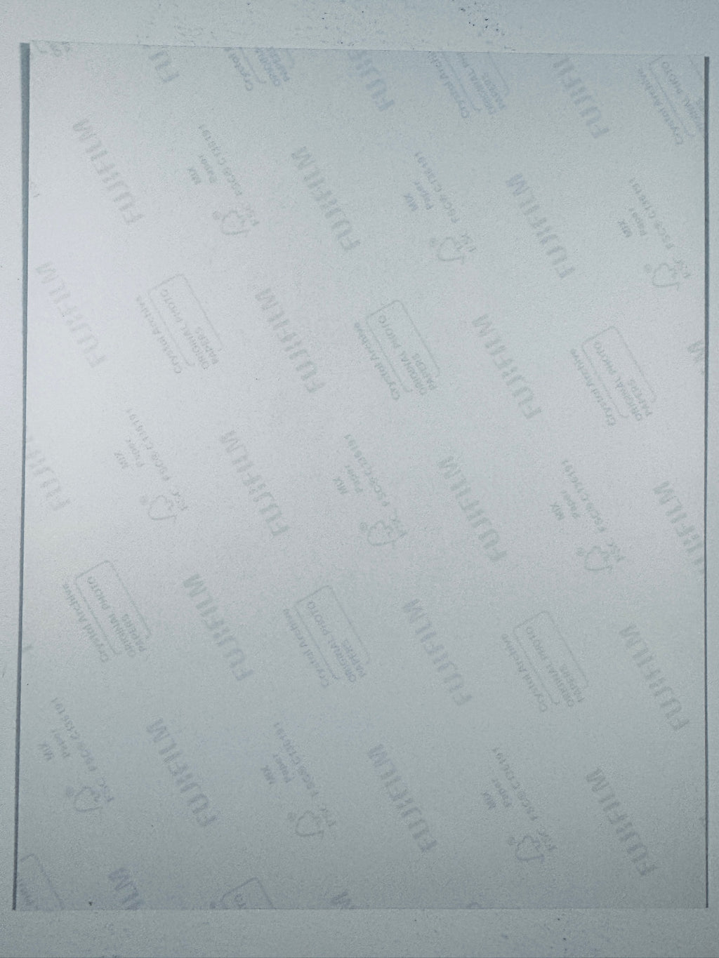 The plain white reverse side representing the back physical condition of the photograph print, showing translucent Fujifilm crystal archive paper watermarks and logos.