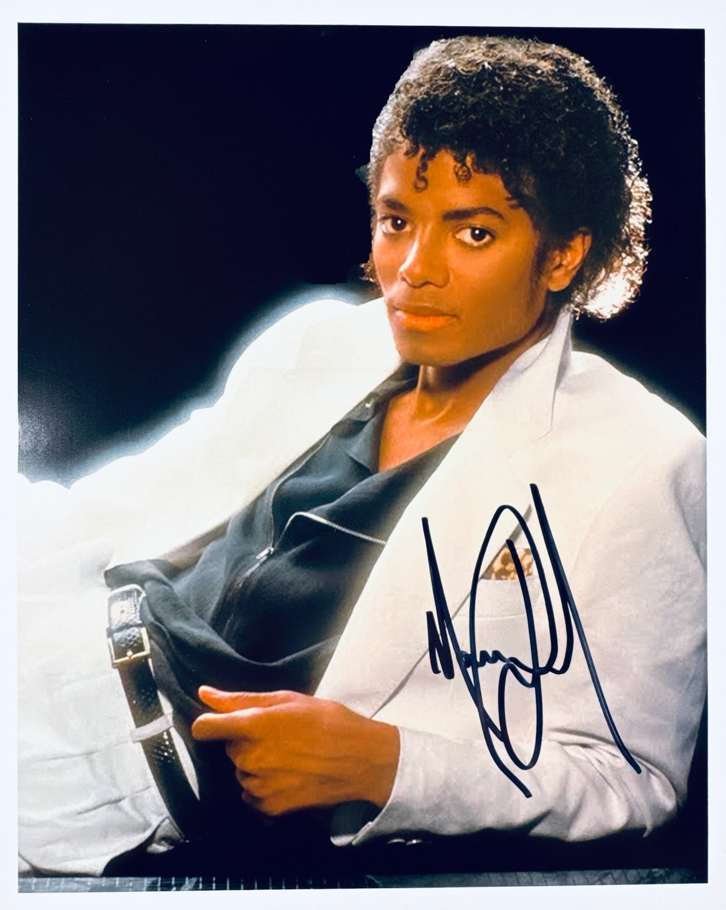 A professional 8x10 photograph featuring an authentic autograph by music legend Michael Jackson.