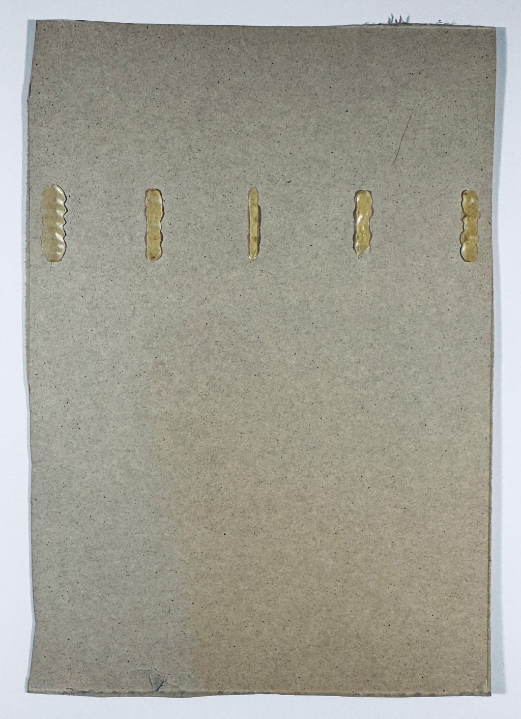 Reverse of the Michael Jordan signed Wheaties cereal box panel showing plain cardboard, five adhesive marks and edge wear.