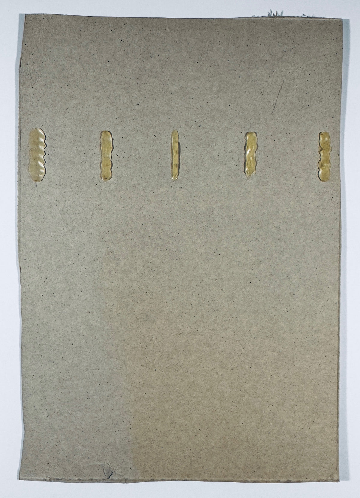Reverse of the Michael Jordan signed Wheaties cereal box panel showing plain cardboard, five adhesive marks and edge wear.