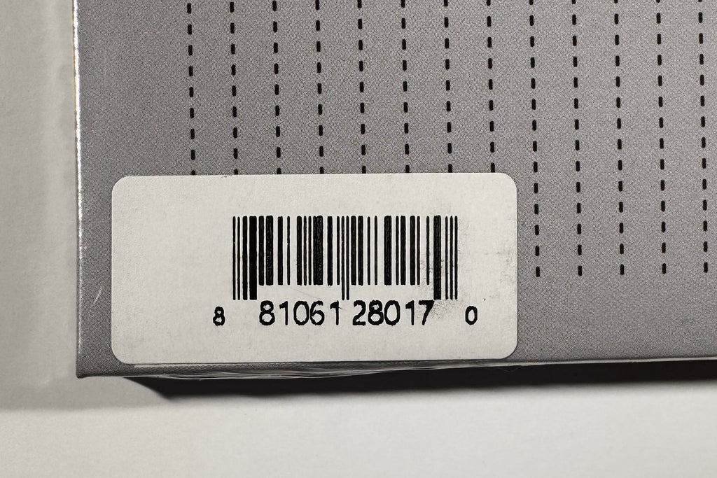 Close-up view of back cover barcode sticker displaying UPC 881061280170.