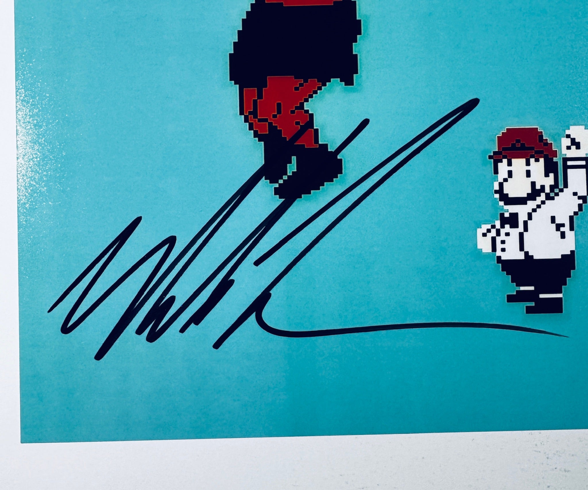 Close-up of Mike Tyson's signature in black marker on the signed Punch-Out!! 8x10 photo.