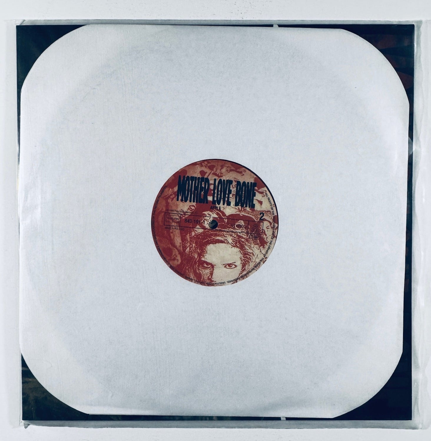 Mother Love Bone Apple pink vinyl album sleeve securely housed inside a clear protective outer sleeve.