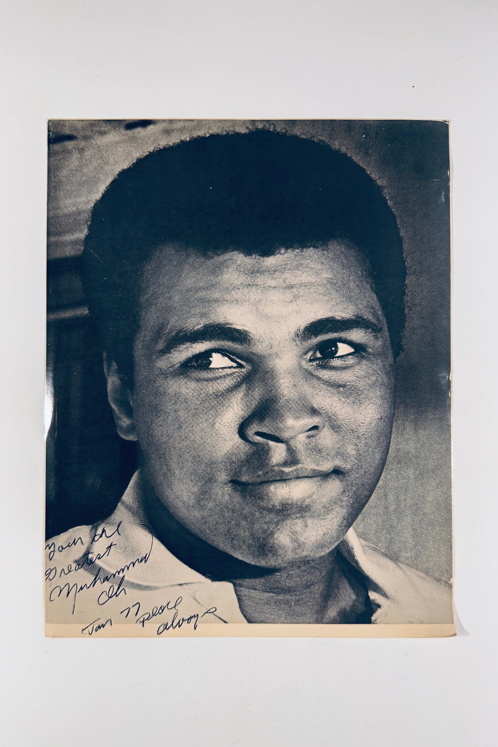 Full front view of vintage black and white 8x10 portrait photo autographed by Muhammad Ali.