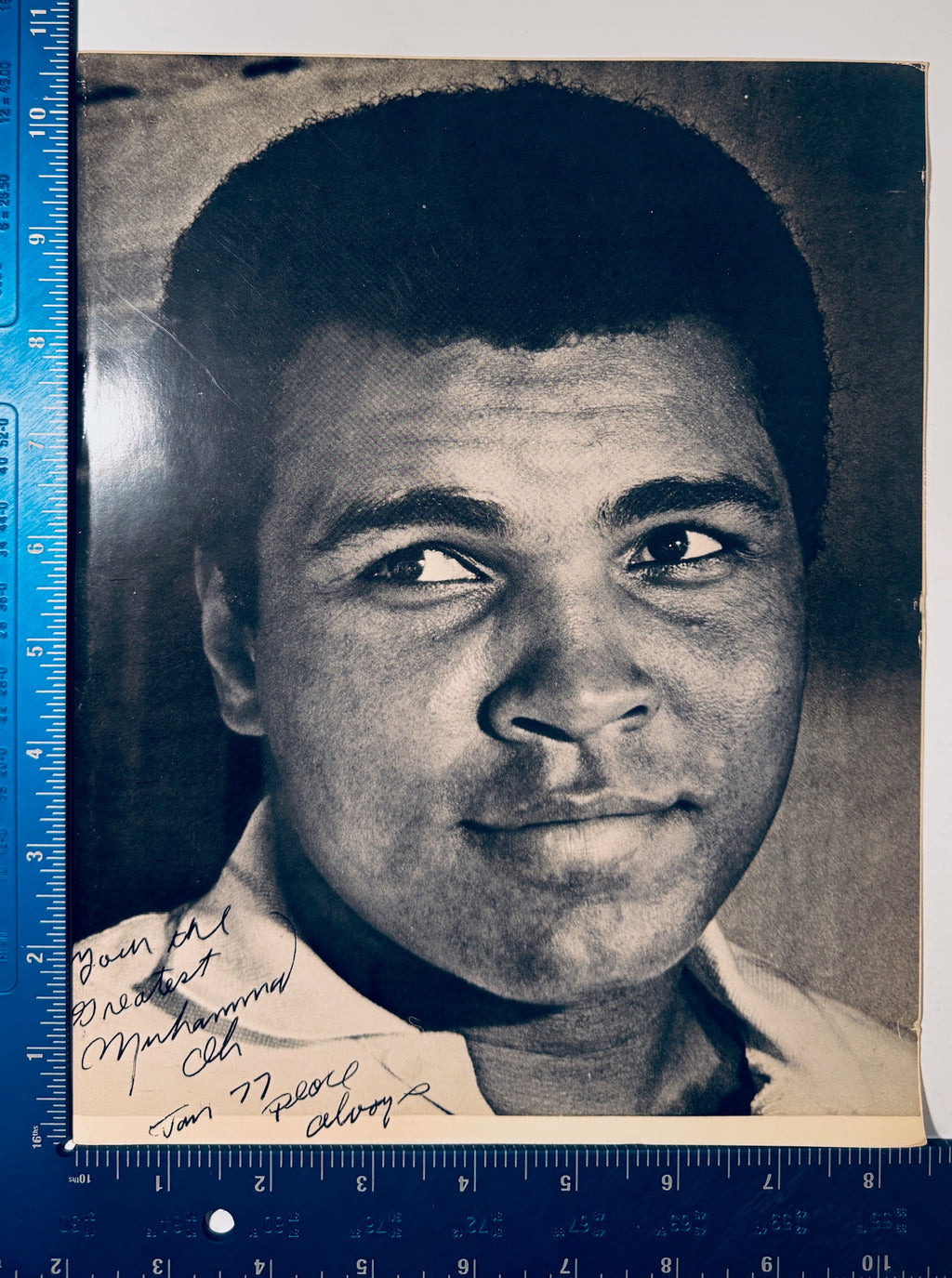 Vintage 8x10 Muhammad Ali autographed photo shown next to a blue ruler measuring 8 by 11 inches.