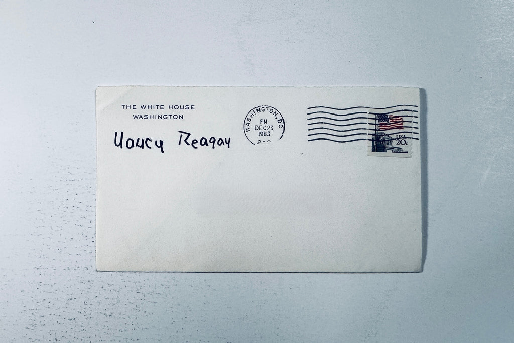 White House envelope featuring a 1983 Washington DC postmark, 20 cent flag stamp, and Nancy Reagan franked signature.