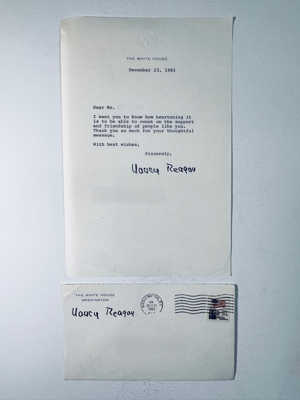 1983 White House typed letter from Nancy Reagan displayed above its matching stamped envelope addressed to a WF.