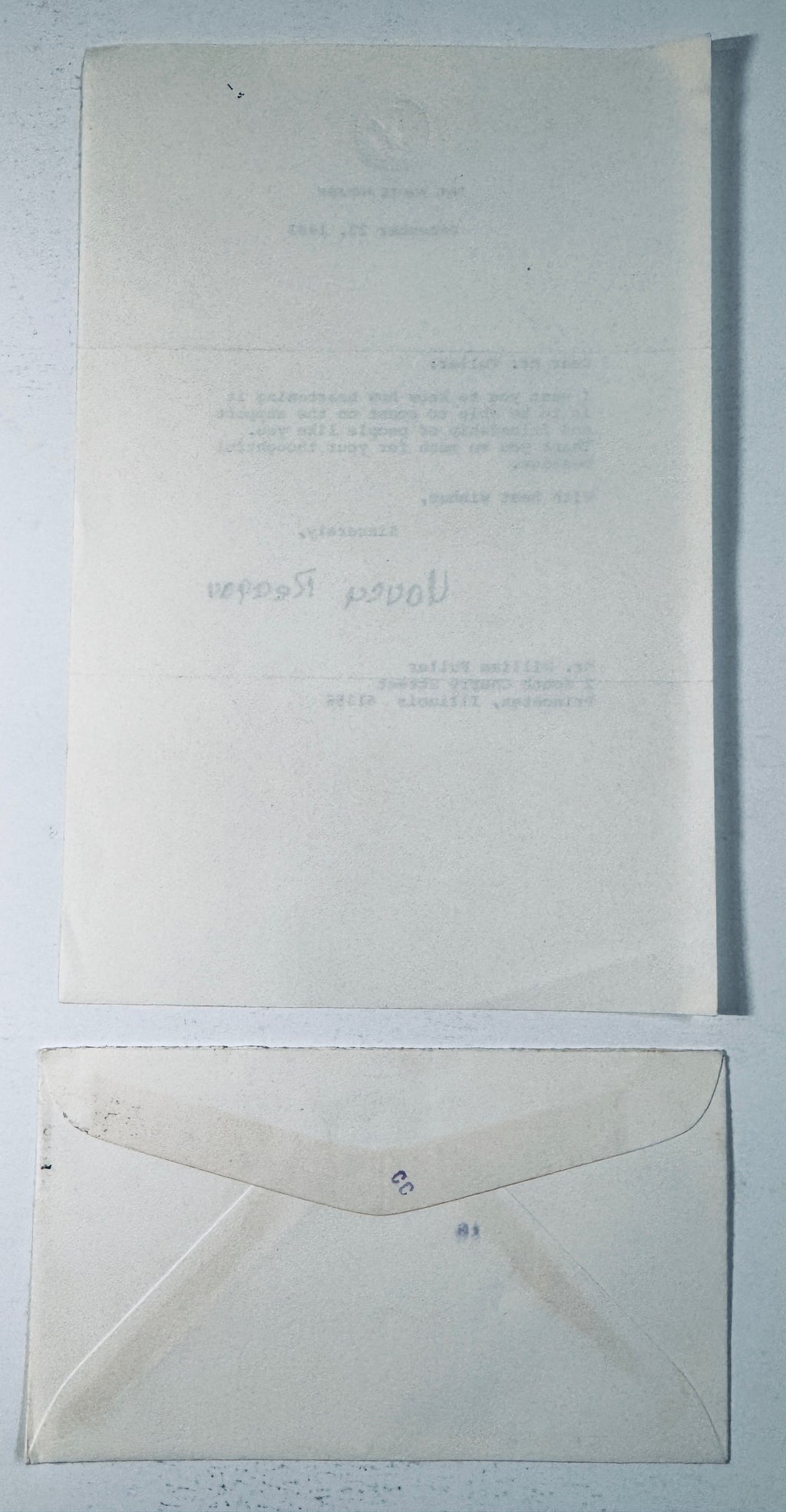 Back side of the 1983 White House letter and envelope showing paper translucency, fold creases, and envelope flap.